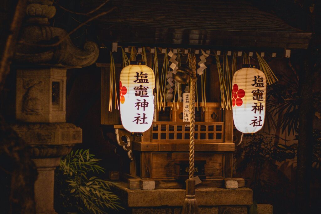Evening lanterns illuminate a traditional Shinto shrine in Kyoto, Japan, showcasing rich cultural heritage.